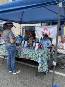Athens Pride Fest tabling. UUFA volunteers speak with community member 